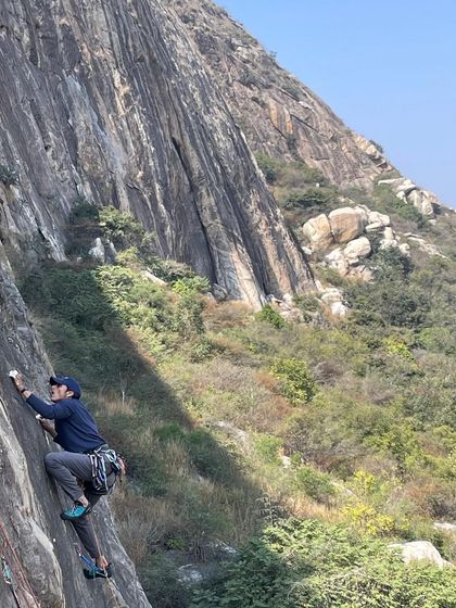 A climber demonstrates great technique on a vertical face at Varlakonda, showcasing the quality of the routes at this crag.