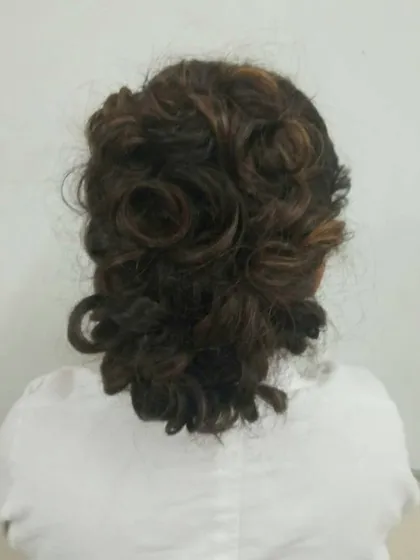 A soft, romantic updo with pinned curls. This style is versatile for many events, and our students learn how to create it for different hair types and lengths.