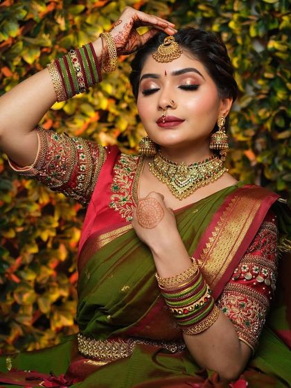 Another angle of the South Indian bridal demonstration, showcasing the intricate hairstyle with a traditional maang tikka and the elegant posture of the model.