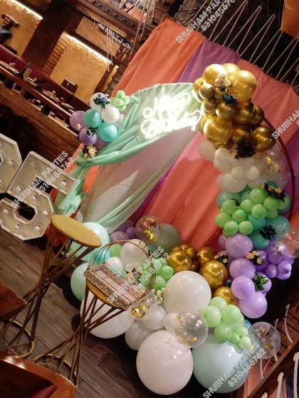 Another angle of the modern balloon ring setup for a 26th birthday in a restaurant.