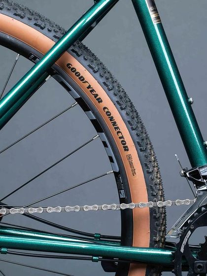 The drivetrain detail of the 'KETTLEXPRESS', showing the Goodyear Connector 650B tires. These wider tires provide a smoother ride on varied surfaces, from pavement to gravel roads.