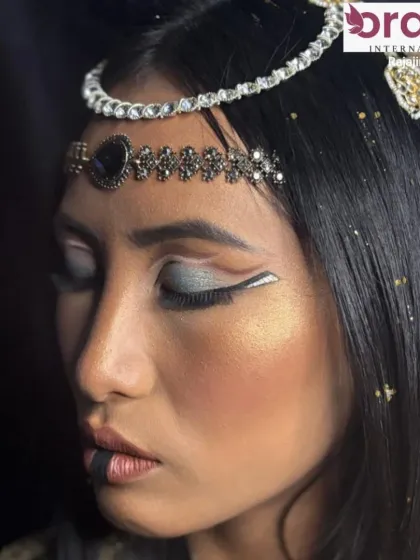 A side view of the Cleopatra look, highlighting the sharp lines of the eyeliner and the intricate headpiece.