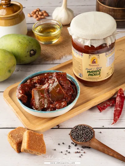 For this mango pickle shoot, I created a rustic, traditional scene to highlight the product's authentic flavor. The composition includes key ingredients like raw mangoes, jaggery, and spices to tell a complete story of taste and quality.