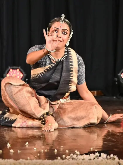 A seated pose from the Odissi recital, showing grace and control.