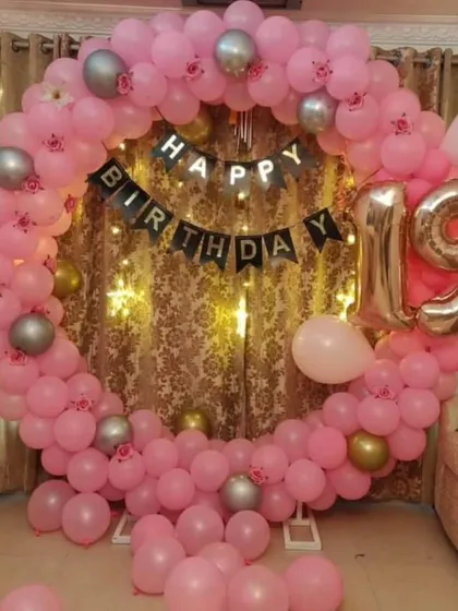A pretty in pink 19th birthday. This full ring decoration uses pink and silver balloons, a "Happy Birthday" banner, and a large "19" foil balloon, creating a perfect backdrop for photos.
