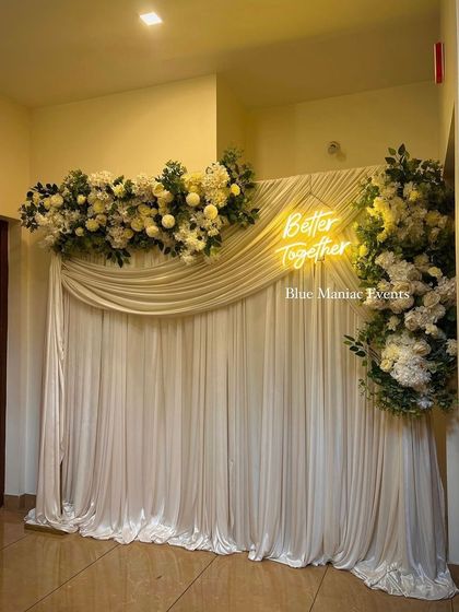 Another angle of the elegant Roka backdrop, showing how the asymmetrical floral design creates a modern and artistic look against the shimmering fabric.