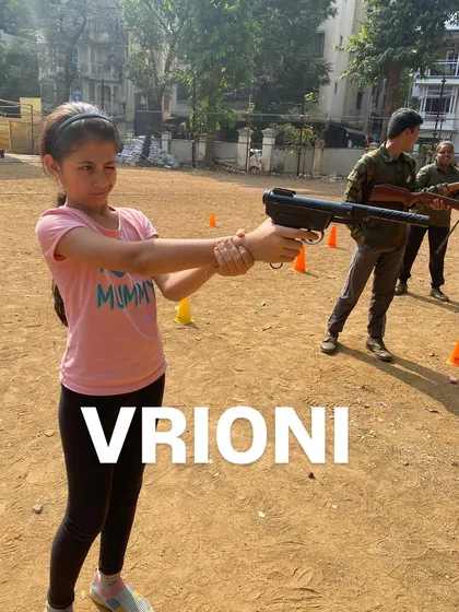 Vrioni confidently holds her stance, ready to take her shot at the target.