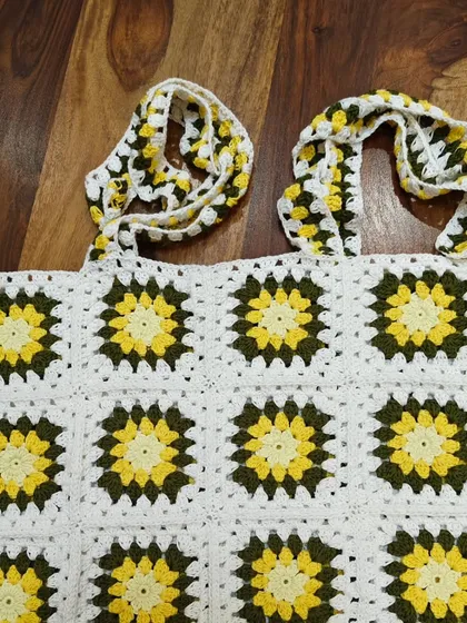 This version of the sunflower top was made with more squares for a longer body, showing how designs can be customized for different preferences.