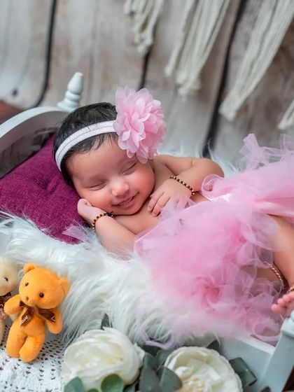 A little ballerina in the making. This adorable setup with a pink tutu and floral headband is perfect for capturing a sweet, girly vibe.