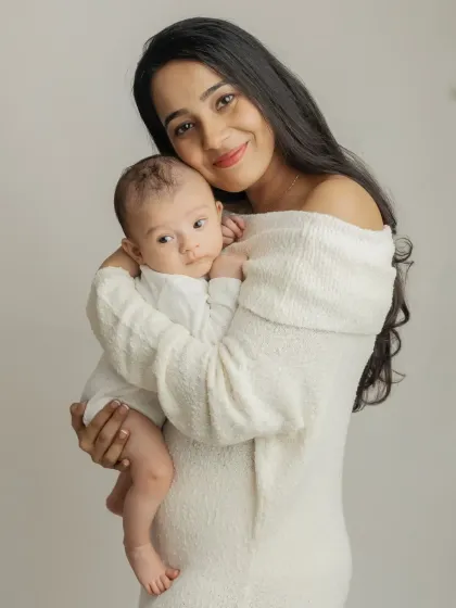A mother and baby portrait where both are looking at the camera, creating a direct and heartfelt connection.