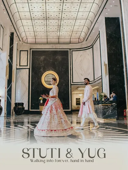 The couple walking through a luxurious hotel lobby, hand in hand, stepping into their forever. A modern and stylish take on a wedding portrait.