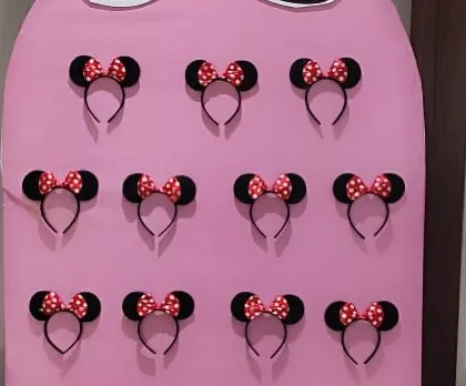 A close-up of the Minnie Mouse ear headbands, ready for guests to pick up and wear during the party.