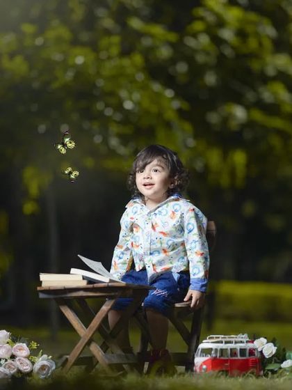 A storybook moment in the park. This whimsical outdoor setup with a book and friendly squirrel prop creates a magical childhood portrait.