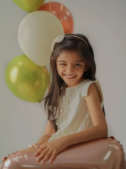 A playful wink from the birthday girl. My sessions are all about having fun, which helps me capture genuine expressions and candid moments like this.