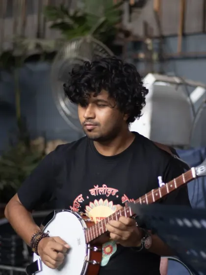 Someone asked how many instruments we have at Let's Jam. Well, here's our multi-talented musician rocking a banjo.