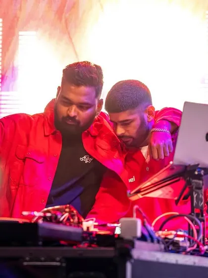 A close-up moment during the Red Bull event, collaborating with another artist to create a seamless set.