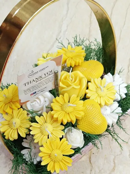 Another angle of the yellow candle bouquet, showing the "Thank You" card.