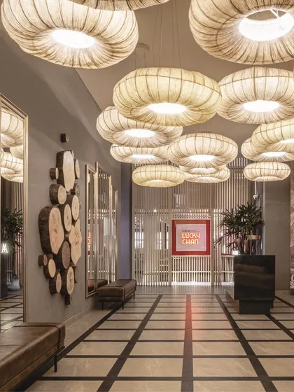 We created drama in the entrance lobby with a massive installation of custom fabric lights. Paired with a lenticular wall and reflective surfaces, this area becomes an iconic and memorable first impression.
