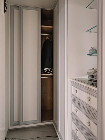 A view of the master closet, with its clean lines, ample storage, and classic two-tone design.