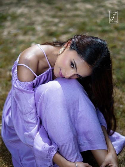 An intimate, gentle pose that draws the viewer in, focusing on the model's expression and the delicate straps of the dress.