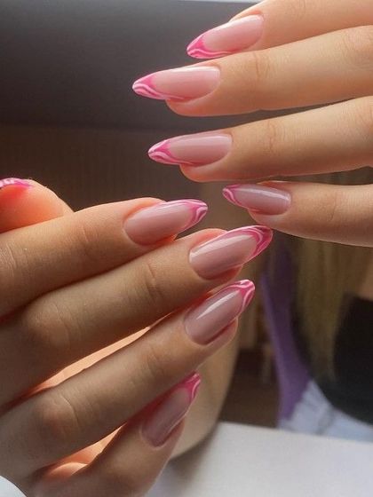 Adding a little fun to the French manicure with these wavy pink tips on a sharp almond nail. It's a playful and trendy take on a classic.