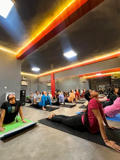 The energy in our group classes is incredible. Here you can see students of different levels moving together in Bhujangasana (Cobra Pose), building back strength and opening their hearts in our Sagar Pur studio.