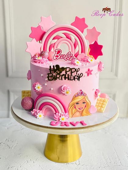 Where dreams are baked into reality. This Barbie cake is fit for a princess, featuring pink rainbows, stars, and of course, Barbie herself.