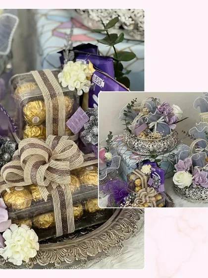 For a touch of pure indulgence, this trousseau packaging features trays of Ferrero Rocher chocolates, beautifully wrapped and presented on ornate silver platters with purple and white floral accents.