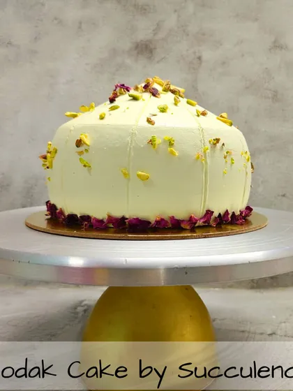 For Ganesh Chaturthi, I offer a modern take on a traditional sweet with my signature Modak Cake. This 100% eggless cake is shaped like a modak and delicately flavored, garnished with premium pistachios and edible rose petals for an elegant finish.