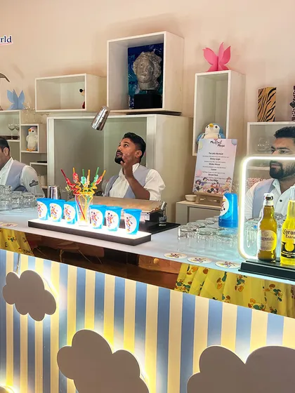 Our team brings energy and expertise to every event. Here's one of our bartenders showing his flair skills at a fun, kid's birthday party-themed bar we designed. We ensure our service is not only professional but also perfectly matched to the atmosphere of your celebration.