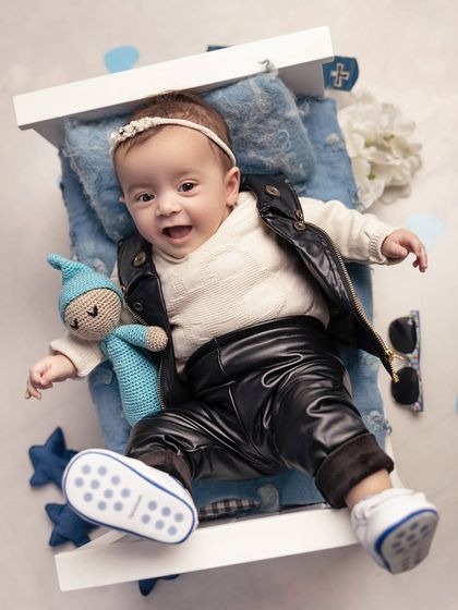 Even the littlest babies can be a boss! This sweet girl is rocking a leather vest and pants, showing that the 'Boss Baby' theme is perfect for boys and girls alike.