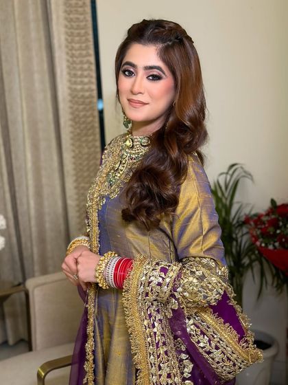 Resplendent in Indian couture for her pre-wedding festivities. This look features a dramatic smoky eye, balanced with a soft nude lip and glowing skin.