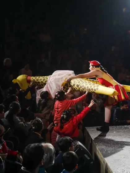 The performers of 'Air Giants Circus' bring a giant, dancing giraffe puppet into the audience. These interactive moments are a highlight of the show, allowing kids to get up close with the magical creatures.