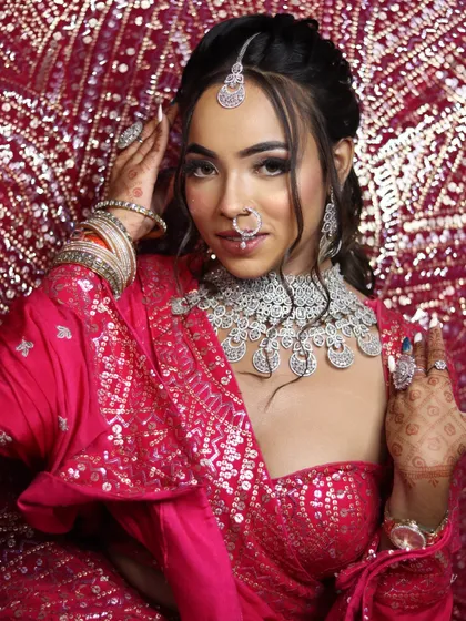 A confident and modern bride. This look features a chic updo, dramatic eye makeup, and perfectly manicured nails, showing the head-to-toe attention to detail you will learn.