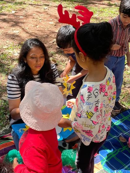 A close-up of a craft activity in progress. The children are gathered around, creating their own suns, connecting a hands-on project to the theme of our story.