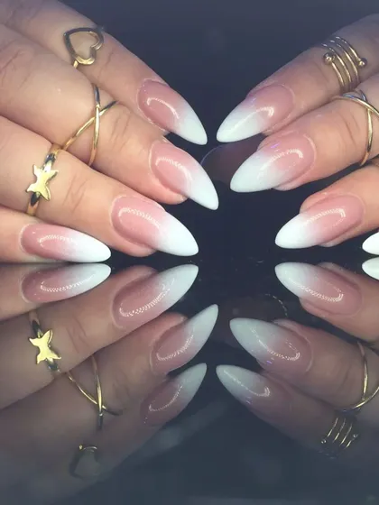A full view of the dramatic stiletto baby boomer manicure, showcasing the perfect gradient.
