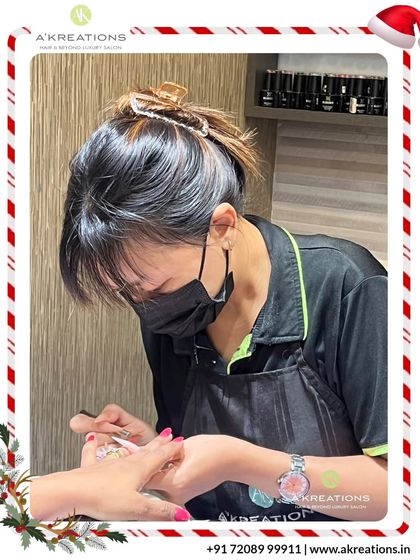 Our nail artist, known for her elegant transformations, is seen here concentrating on the fine details of a client's nail art.