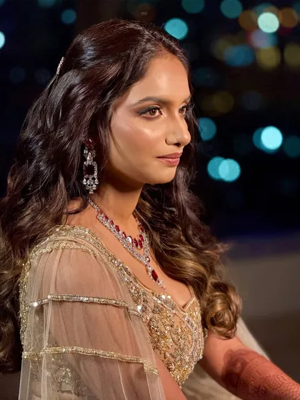 A side profile against the city lights, creating a beautiful bokeh effect that highlights her glamorous look.