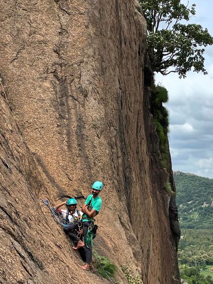 Two climbers at a hanging belay on a multi pitch route at Talai Betta. This showcases the technical skills and teamwork required for big wall climbing.