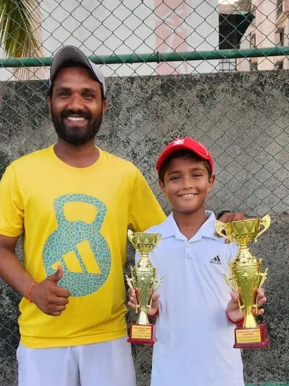 A coach celebrating with Aarav Chhallani after his successful tournament at the Sania Mirza Tennis Academy.