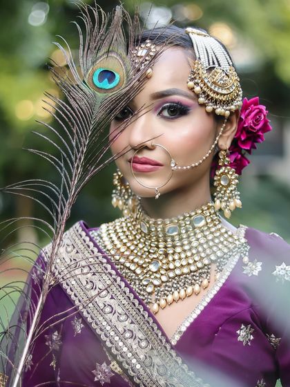 A close-up portrait with a peacock feather, adding an artistic touch to this traditional look.