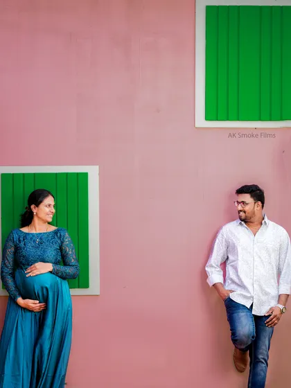 This creatively composed shot shows the couple looking at each other across the frame. It's a modern and artistic way to represent the connection and anticipation of expecting parents.