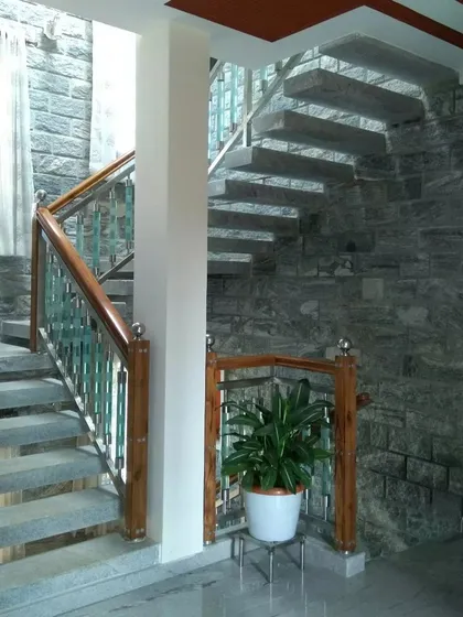 A floating staircase made of stone slabs, creating a sense of lightness and openness in the stairwell.