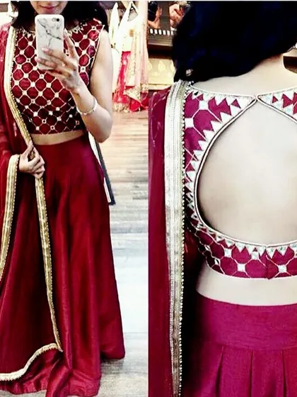 A deep red lehenga paired with a stylish keyhole back blouse. We can customize both the lehenga skirt and the blouse design to create a complete, coordinated look.