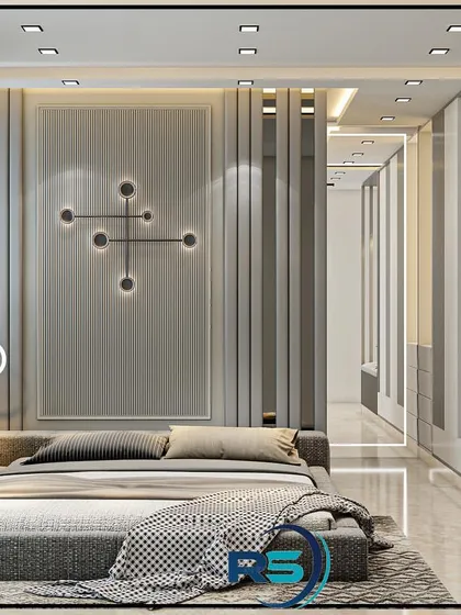 This bedroom uses vertical slats and wall molding to create a sense of height and texture. The low, platform-style bed and minimalist decor contribute to a modern and uncluttered feel.