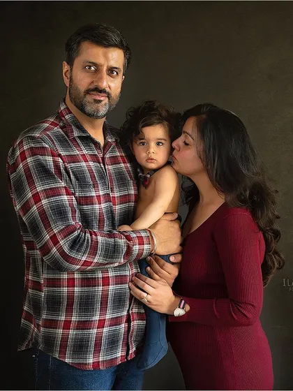 A simple, classic family portrait against a dark background. My goal is to create a timeless image that focuses on the connection between you and your children, a memory you'll cherish forever.