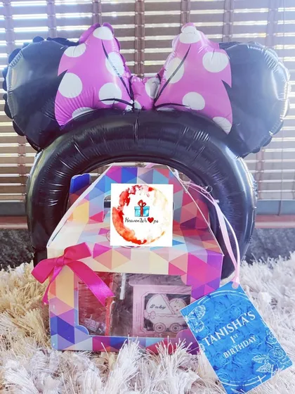 A fun and vibrant return gift for a child's first birthday party, featuring a large Minnie Mouse ears balloon. I handle bulk orders for events, ensuring each guest leaves with a memorable and personalized party favor.