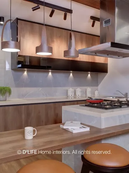 This open kitchen features a breakfast bar with leather-topped stools, wood-finish cabinets, and modern track lighting, creating a warm and industrial-chic vibe.
