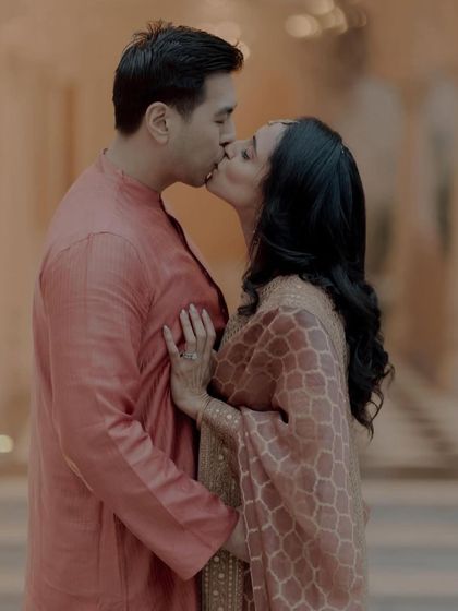 An intimate kiss, a testament to their love story. The makeup is flawless and designed to look perfect even in the most personal moments.