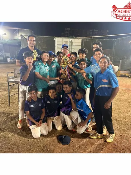 The full U-11 team celebrating their hard-fought victory in the night tournament.